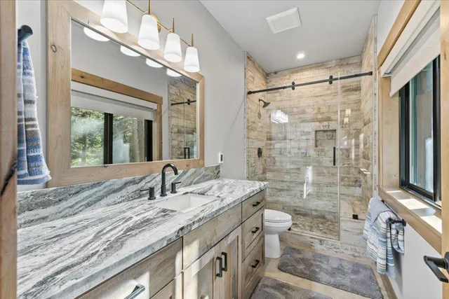a bathroom with a sink a vanity and a mirror