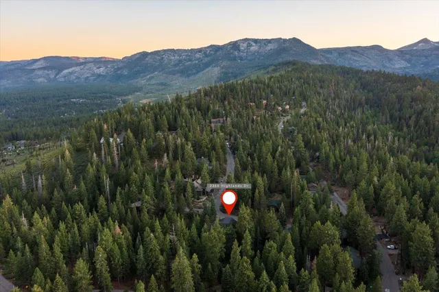 a view of a lush green hillside and a houses