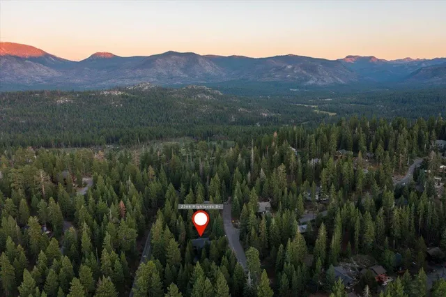 a view of a lush green hillside and a houses