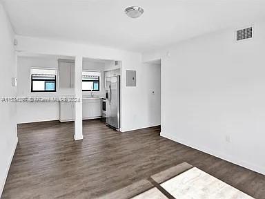 4203 Southwest 15th Street, Unit 2 Miami, FL 33145 - Photo 7 of 13 an empty room with a wooden floor and white walls