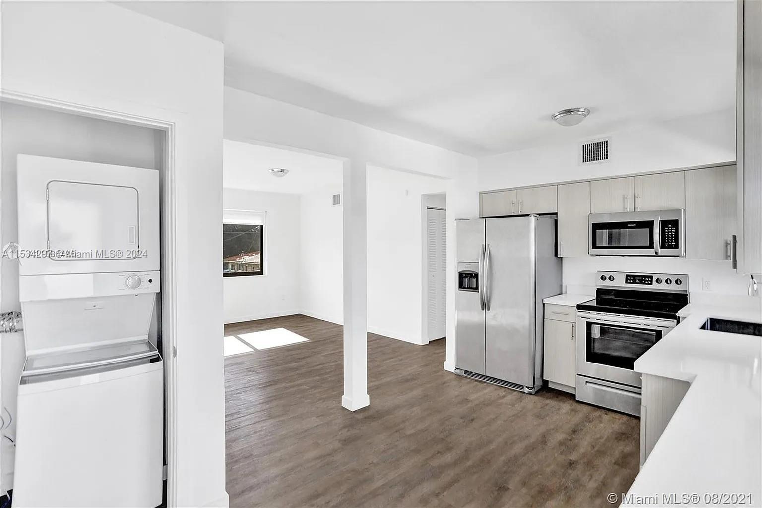 4203 Southwest 15th Street, Unit 2 Miami, FL 33145 - Photo 9 of 13 a kitchen with stainless steel appliances a refrigerator and a stove top oven