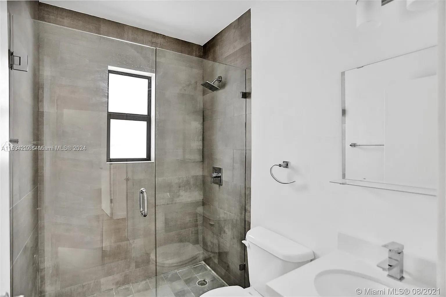 4203 Southwest 15th Street, Unit 2 Miami, FL 33145 - Photo 10 of 13 a bathroom with a shower and toilet