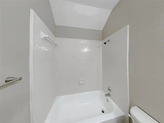 a white bath tub sitting next to a white toilet
