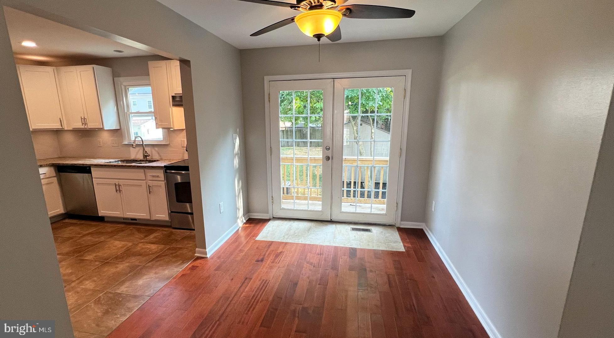 2505 229th Street Pasadena, MD 21122 - Photo 5 of 29 Dining room, doors to the back deck