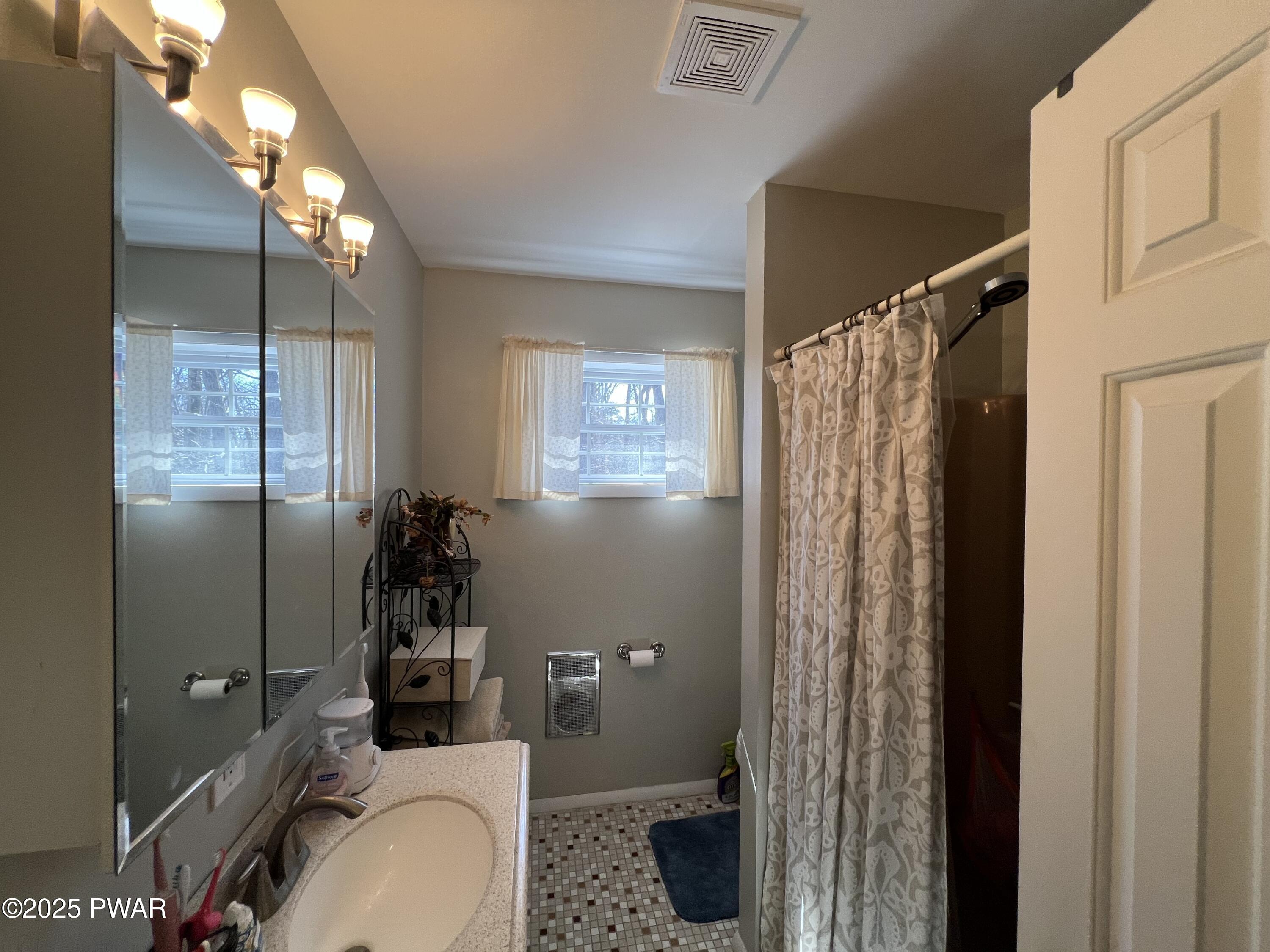 119 Rodeo Drive Hawley, PA 18428 - Photo 31 of 34 a bathroom with a sink toilet and shower