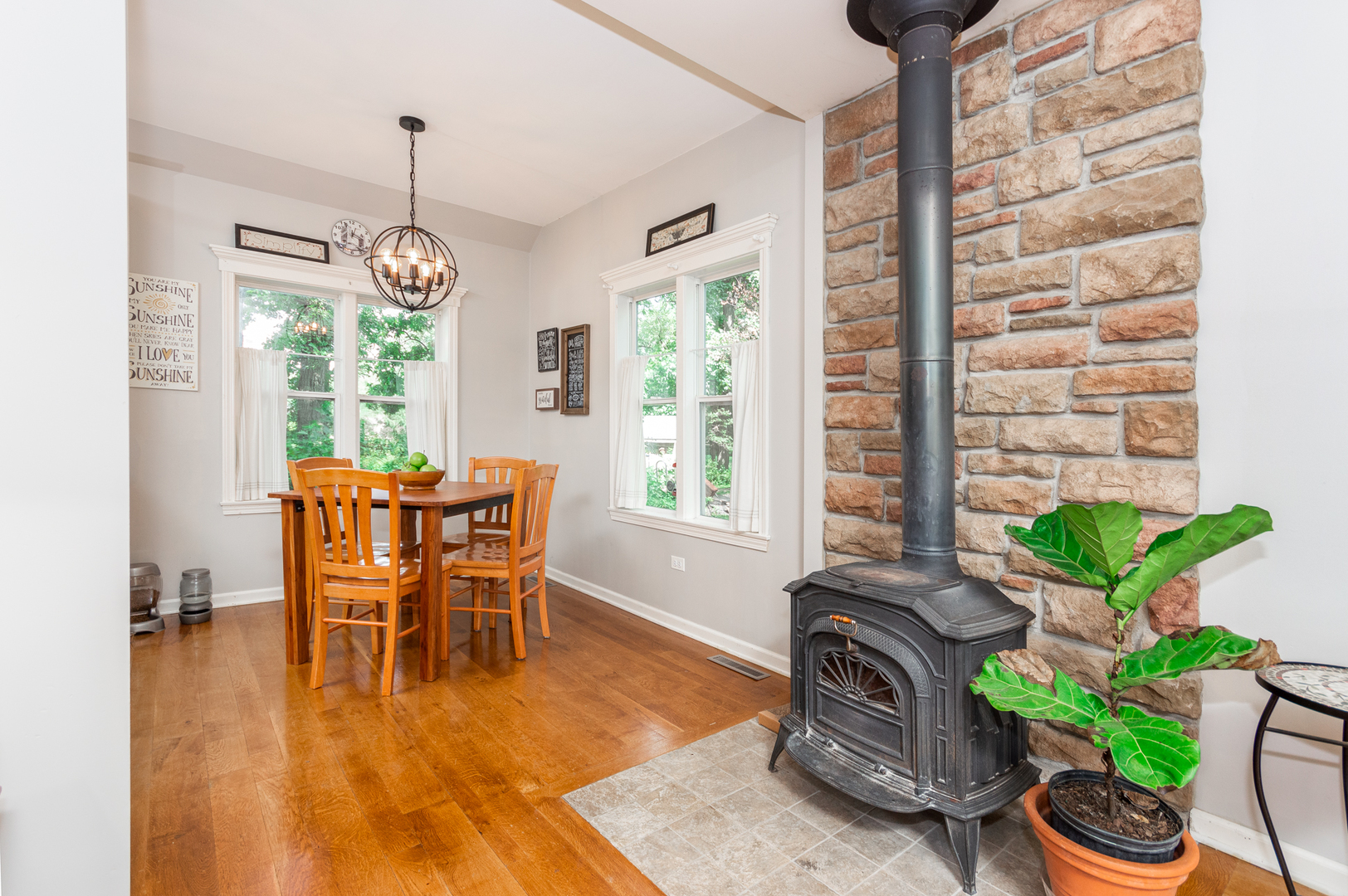 16463 Plank Road Sycamore, IL 60178 - Photo 14 of 36 a dining room with furniture potted plants and wooden floor