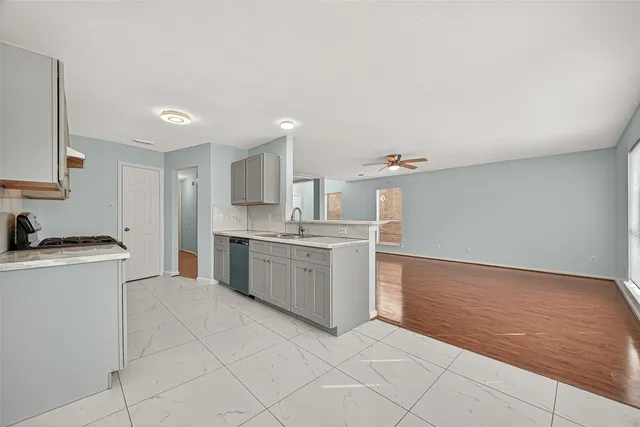 a kitchen with a stove a sink and a refrigerator