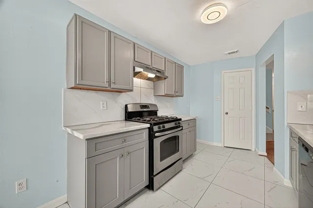 a kitchen with stainless steel appliances granite countertop a stove and a sink