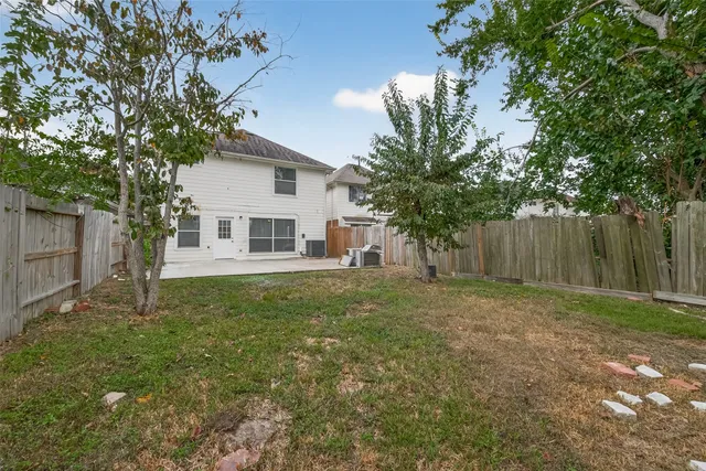 a backyard of a house with table and sofas