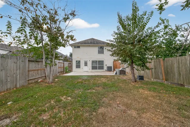 a white house that has a tree in front of it