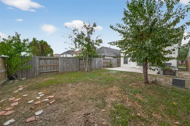a view of a house with a yard and tree s