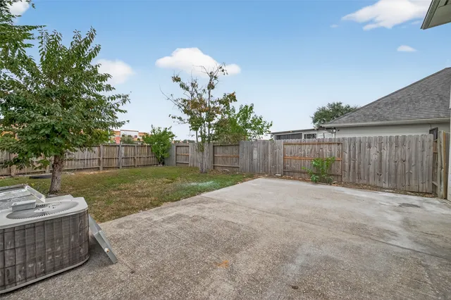 a view of a backyard with a garden and entertaining space