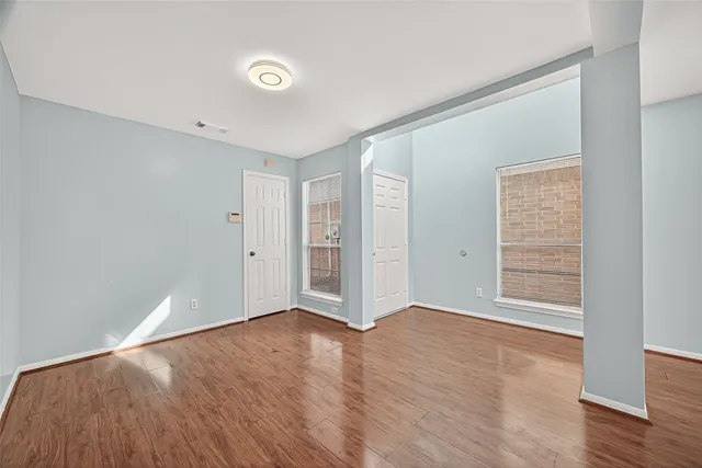 wooden floor in an empty room with a window