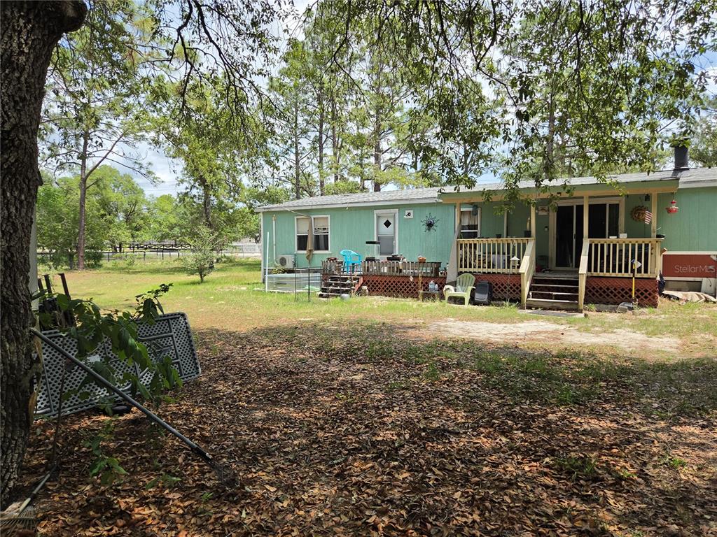 4738 Southwest 166th Court Road Ocala, FL 34481 - Photo 14 of 14 a view of a house with backyard and sitting area