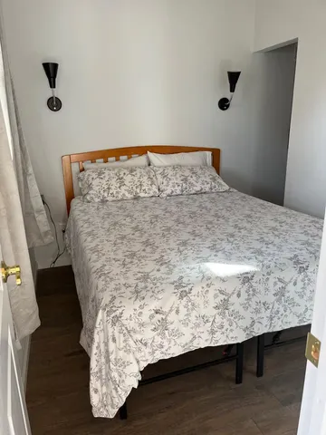 a bedroom with a bed and window