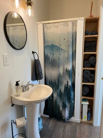 a bathroom with a toilet a sink and a mirror