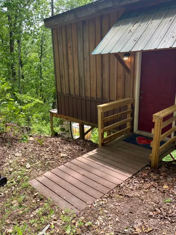 a view of a backyard with a chair and wooden fence