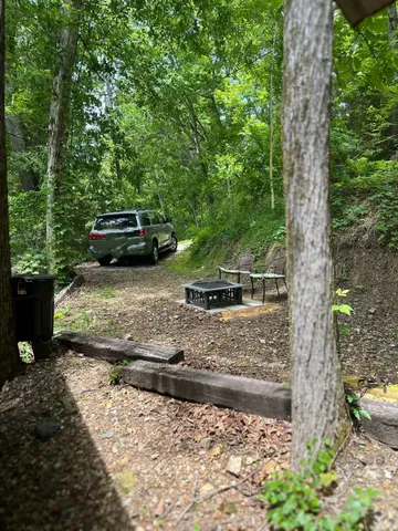 a view of a backyard with table and chairs and a fire pit