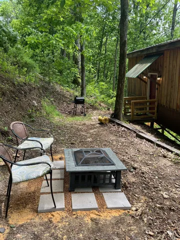 a backyard of a house with table and chairs