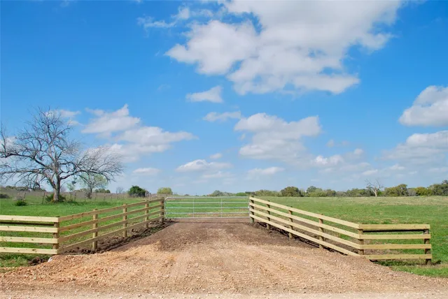 a view of a street with a yard
