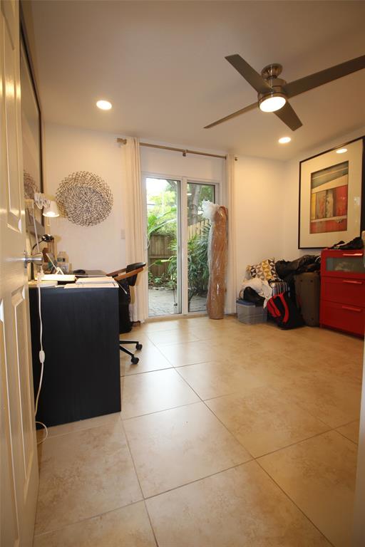 820 Northeast 28th Street, Unit 1 Wilton Manors, FL 33334 - Photo 12 of 17 a room with gym equipment and a large window