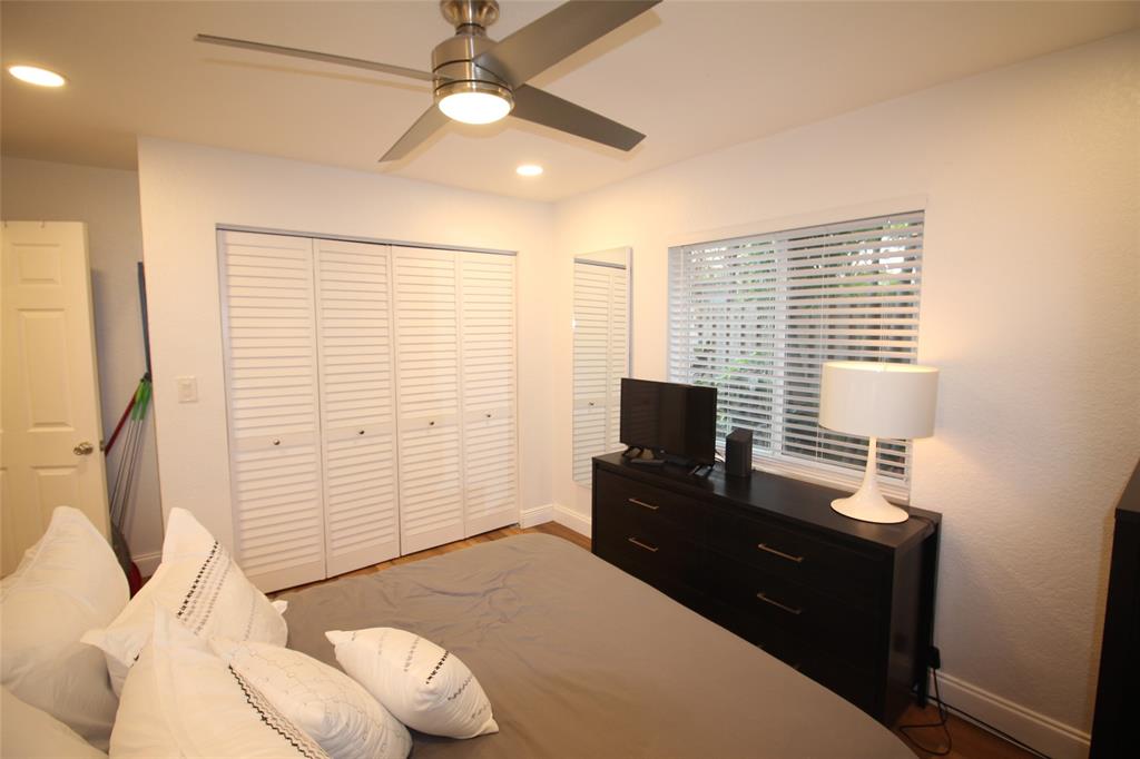 820 Northeast 28th Street, Unit 1 Wilton Manors, FL 33334 - Photo 13 of 17 a bedroom with a bed and a flat screen tv