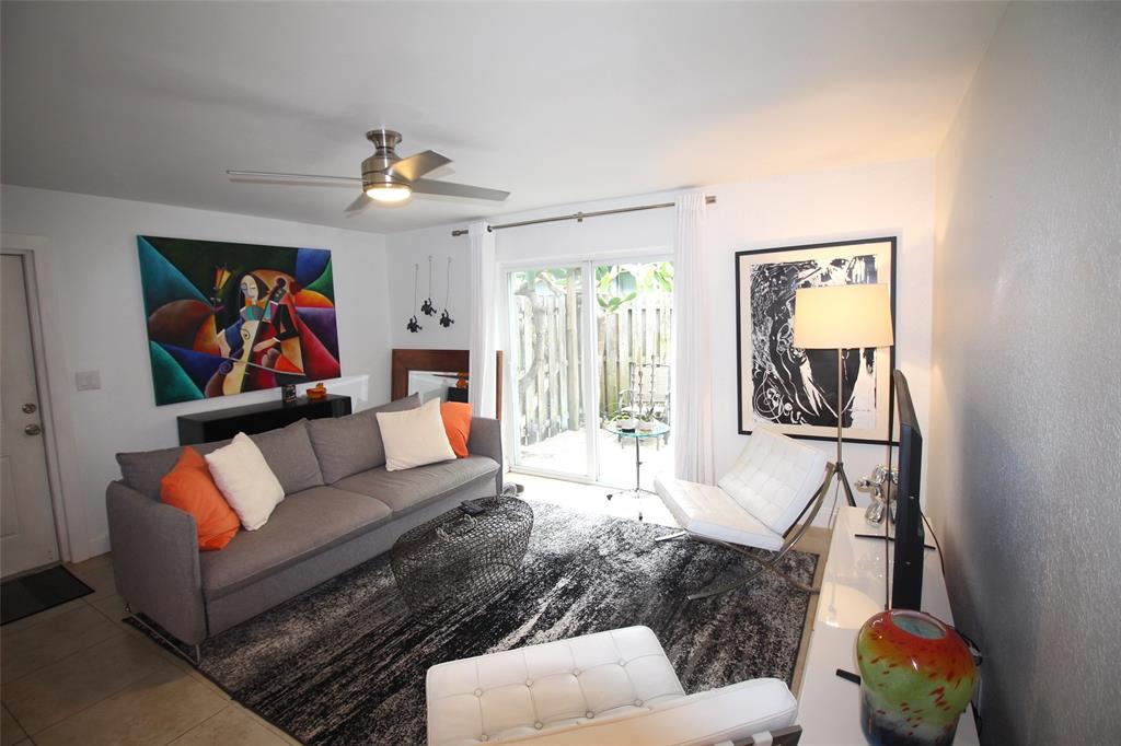 820 Northeast 28th Street, Unit 1 Wilton Manors, FL 33334 - Photo 15 of 17 a living room with furniture flowerpot and a window