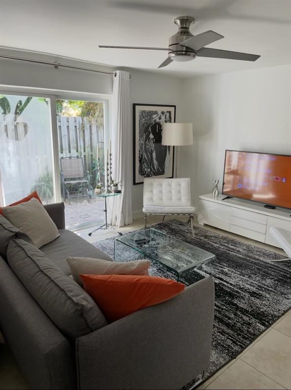 820 Northeast 28th Street, Unit 1 Wilton Manors, FL 33334 - Photo 3 of 17 a living room with furniture and a rug