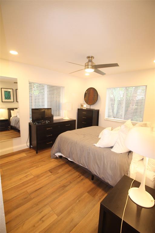820 Northeast 28th Street, Unit 1 Wilton Manors, FL 33334 - Photo 5 of 17 a bedroom with a bed and wooden floor
