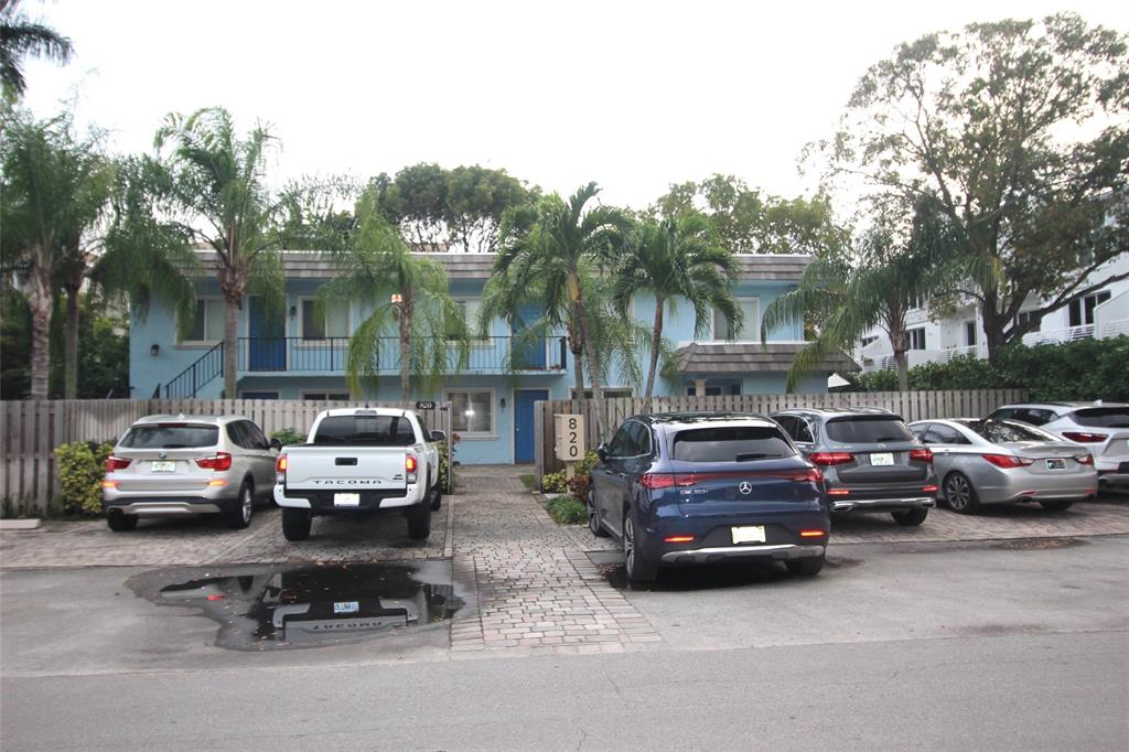 820 Northeast 28th Street, Unit 1 Wilton Manors, FL 33334 - Photo 6 of 17 a car parked in front of a houses