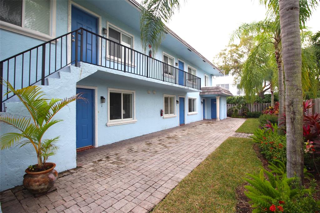 820 Northeast 28th Street, Unit 1 Wilton Manors, FL 33334 - Photo 7 of 17 a front view of a house with a yard