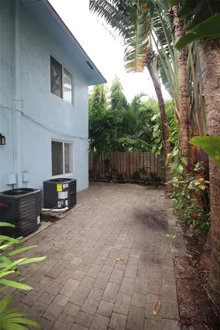 a view of a backyard with furniture and a tree