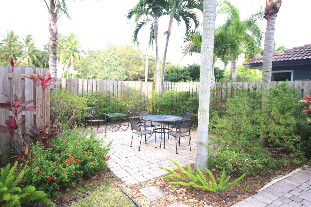 820 Northeast 28th Street, Unit 1 Wilton Manors, FL 33334 - Photo 10 of 17 a view of a chair and table in backyard of the house
