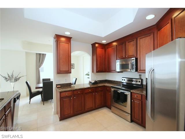 2104 West First Street, Unit 3204 Fort Myers, FL 33901 - Photo 13 of 21 a kitchen with stainless steel appliances granite countertop a stove a sink dishwasher a refrigerator and a microwave