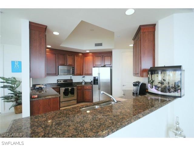 2104 West First Street, Unit 3204 Fort Myers, FL 33901 - Photo 15 of 21 a kitchen with stainless steel appliances granite countertop a sink stove and refrigerator