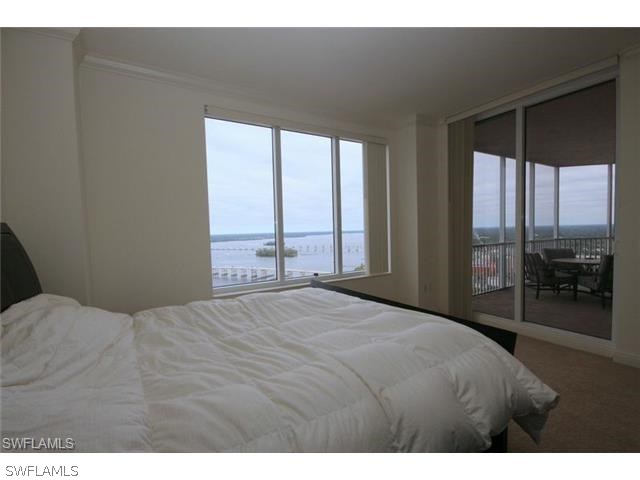 2104 West First Street, Unit 3204 Fort Myers, FL 33901 - Photo 20 of 21 a bedroom with a large bed and a large window