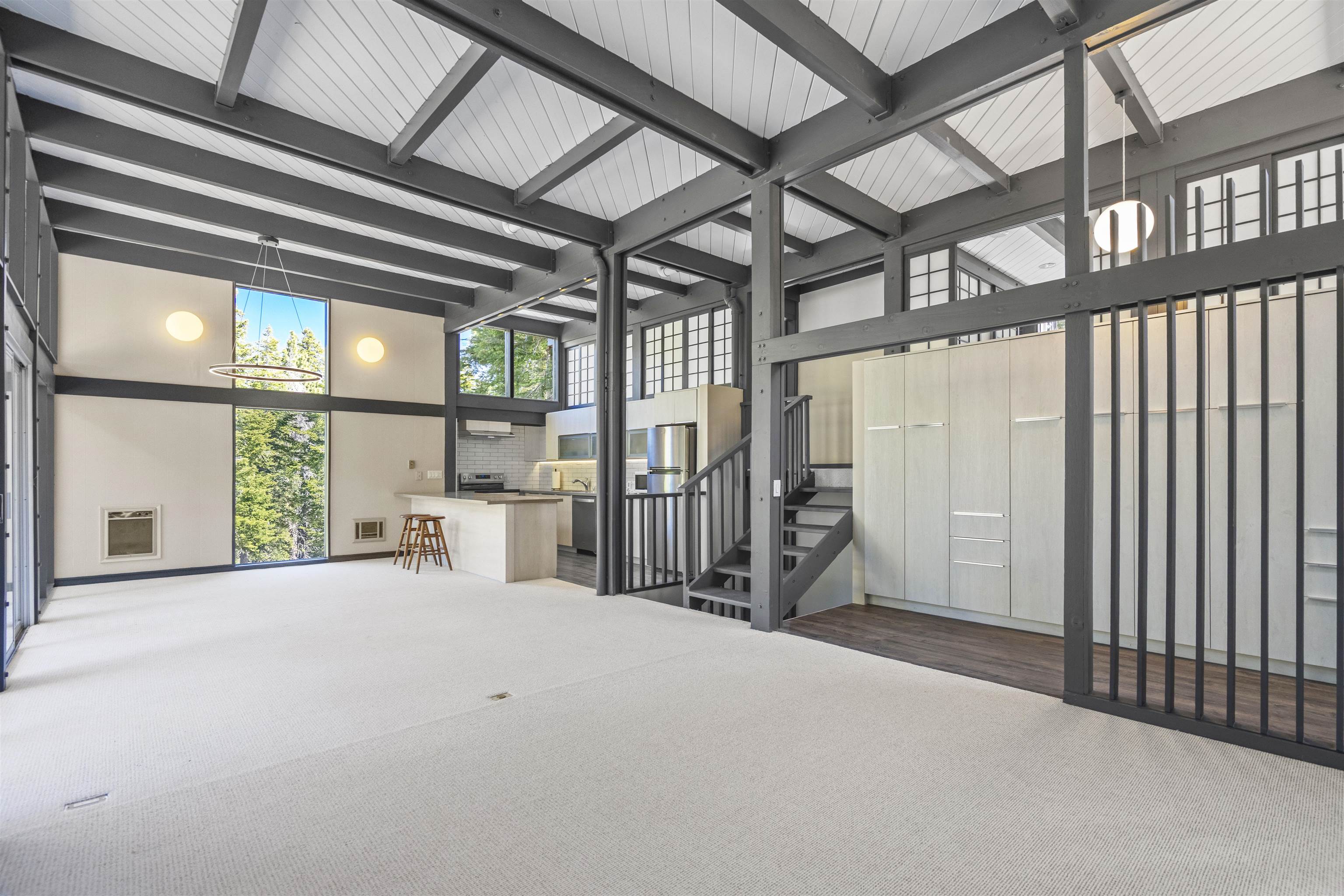 2570 Old Mammoth Road Mammoth Lakes, CA 93546 - Photo 5 of 39 Vaulted ceiling with exposed dark wood beams and white tongue-and-groove paneling