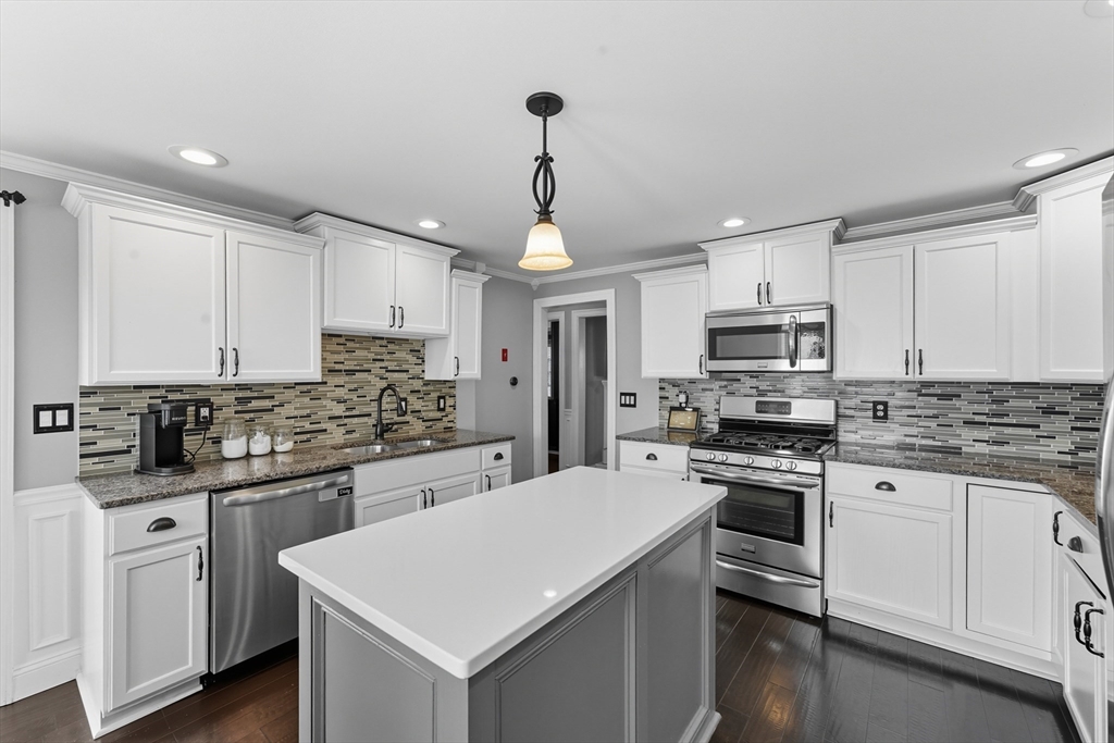 53 Druids Lane West Springfield, MA 01089 - Photo 15 of 42 a kitchen with white cabinets sink and stainless steel appliances