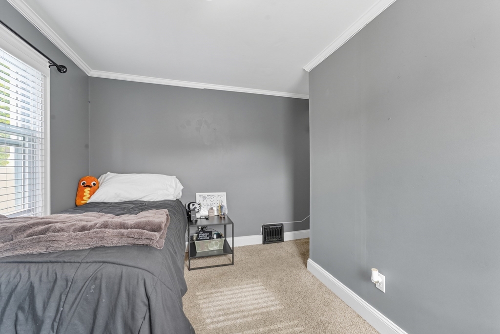 53 Druids Lane West Springfield, MA 01089 - Photo 32 of 42 a bedroom with a bed and chair