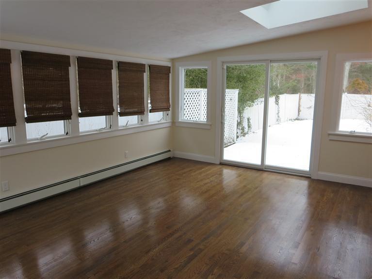 138 South Main Street Centerville, MA 02632 - Photo 12 of 35 an empty room with wooden floor and windows