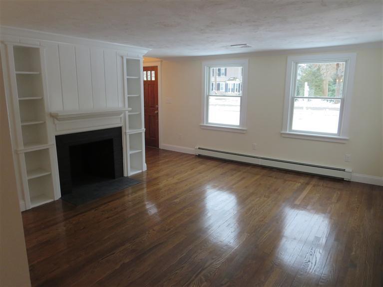 138 South Main Street Centerville, MA 02632 - Photo 15 of 35 an empty room with wooden floor fireplace and windows