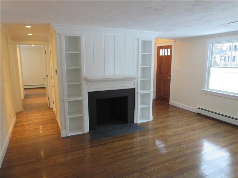 138 South Main Street Centerville, MA 02632 - Photo 16 of 35 an empty room with wooden floor a fireplace and windows