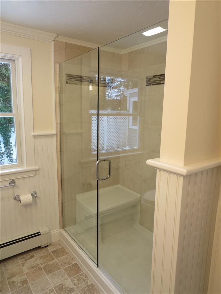 138 South Main Street Centerville, MA 02632 - Photo 23 of 35 a bathroom with a glass shower door and a window
