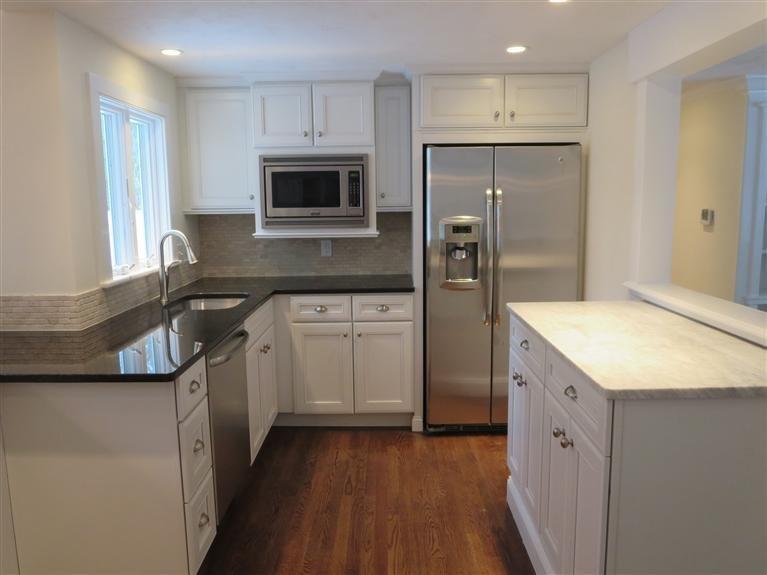 138 South Main Street Centerville, MA 02632 - Photo 3 of 35 a kitchen with white cabinets and stainless steel appliances