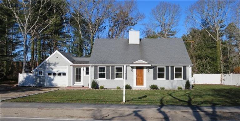 138 South Main Street Centerville, MA 02632 - Photo 35 of 35 a view of a white house next to a yard with plants and trees