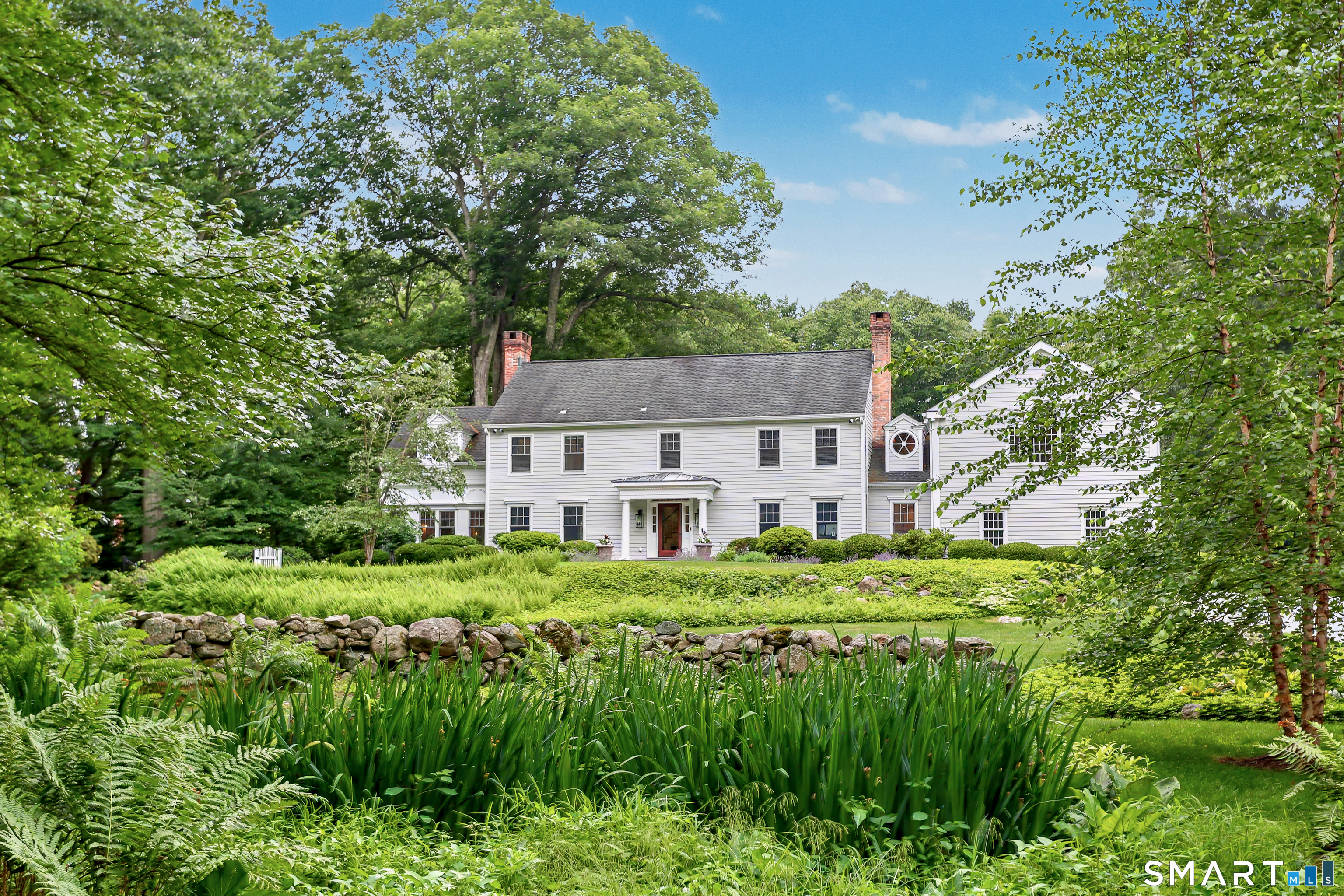 108 Logan Road New Canaan, CT 06840 - Photo 39 of 40 a house view with a garden space