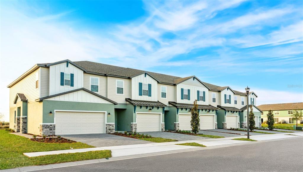2433 Magnolia Reserve Road Ocoee, FL 34761 - Photo 1 of 14 a front view of a house with a garden