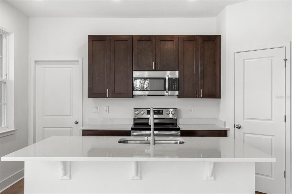 2433 Magnolia Reserve Road Ocoee, FL 34761 - Photo 8 of 14 a kitchen with a cabinets and appliances