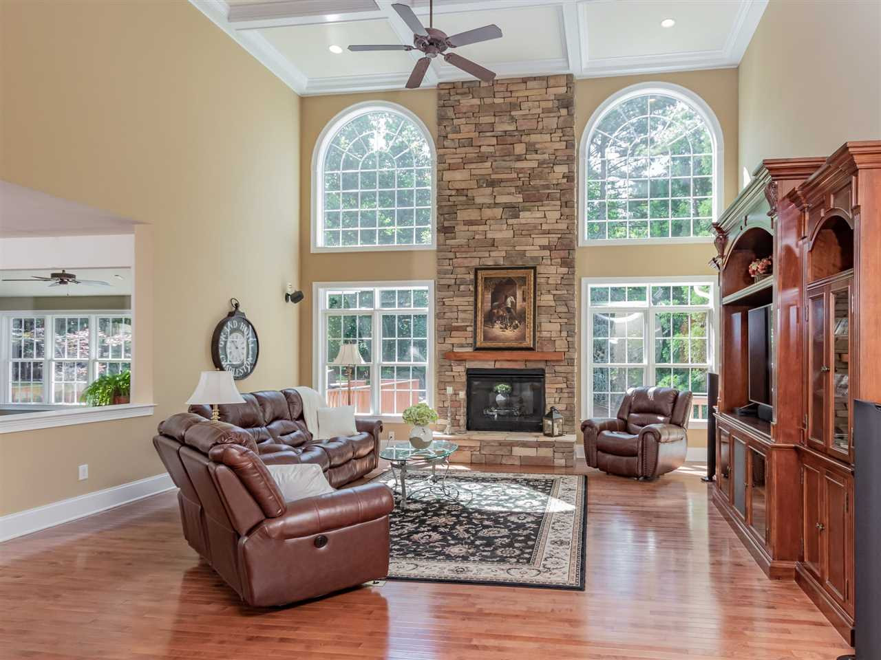 4717 Haleytree Court Raleigh, NC 27606 - Photo 7 of 30 Huge family room! This room was extended 8' from the original plan...just gorgeous! Two stories high plus a stone fireplace surround from floor to ceiling. Tons of upgrades in this home! Coffered ceiling too! Den/Family/Great Room