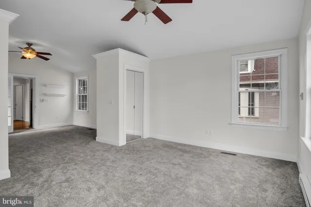 a view of empty room with ceiling fan